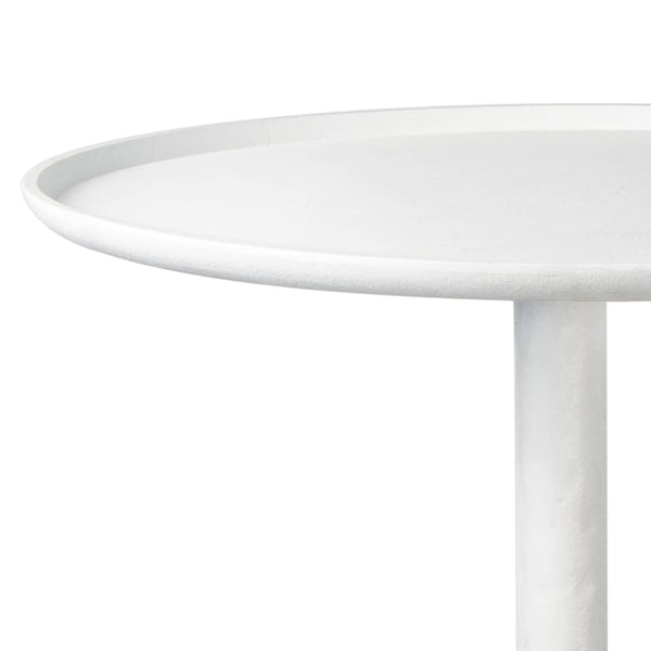 Matte white accent table with a round top and unique, sculptural curves.