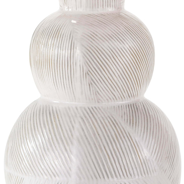 Hugo ceramic table lamp with a textured white earthenware base and subtle highs and lows.