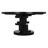 Hugo round mahogany dining table with hand-rubbed black finish and stacked geometric disc base.