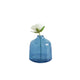 Blue glass vase with a white flower on a white background