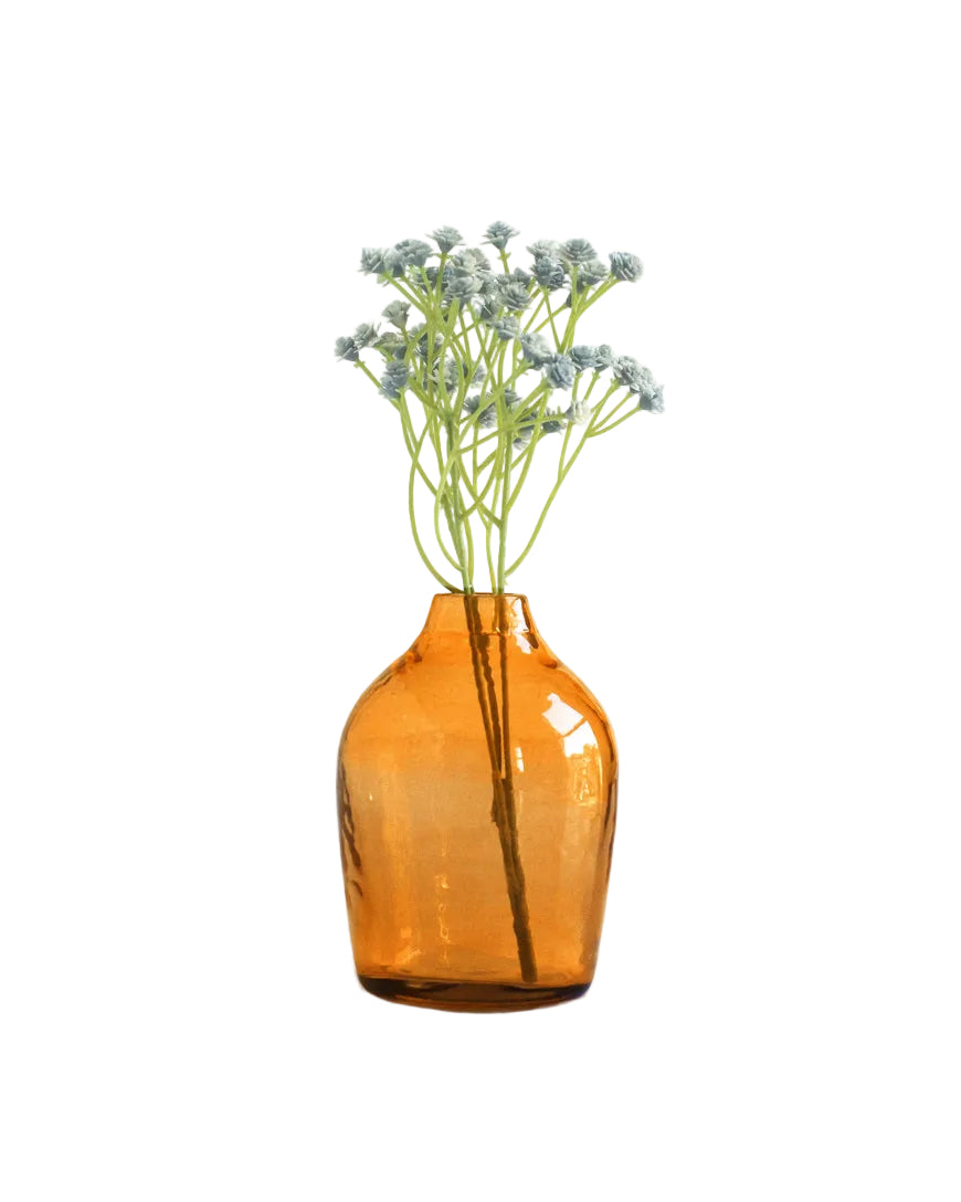 Amber glass vase with flowers on a white background