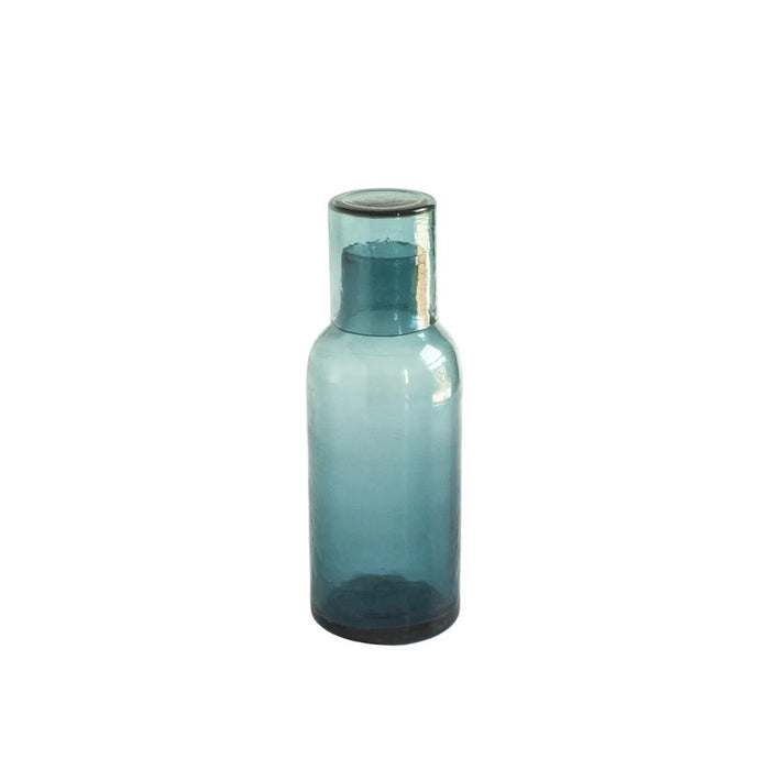 Turquoise glass drink decanter on a white background