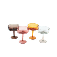 Four colorful cocktail glasses on a white background