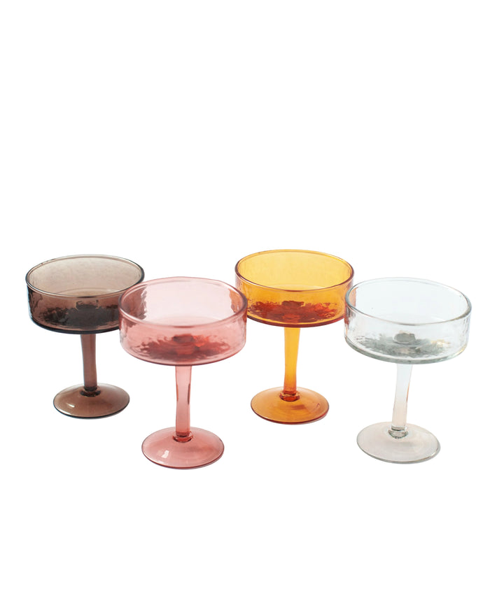Four colorful cocktail glasses on a white background