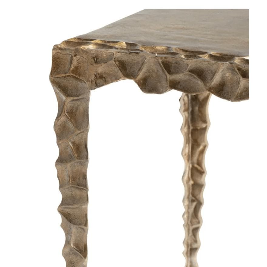 Antique brass aluminum accent table with square top and textured, indented edges and legs.