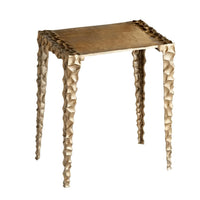 Antique brass aluminum accent table with square top and textured, indented legs.