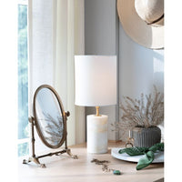 Elegant jade & brass mini cylinder lamp with a natural linen drum shade on a wooden table.