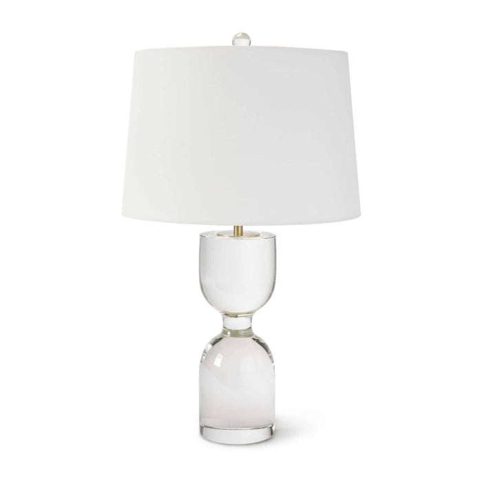 Joan large crystal table lamp with a clear solid crystal body, natural brass accents, and a white linen shade.