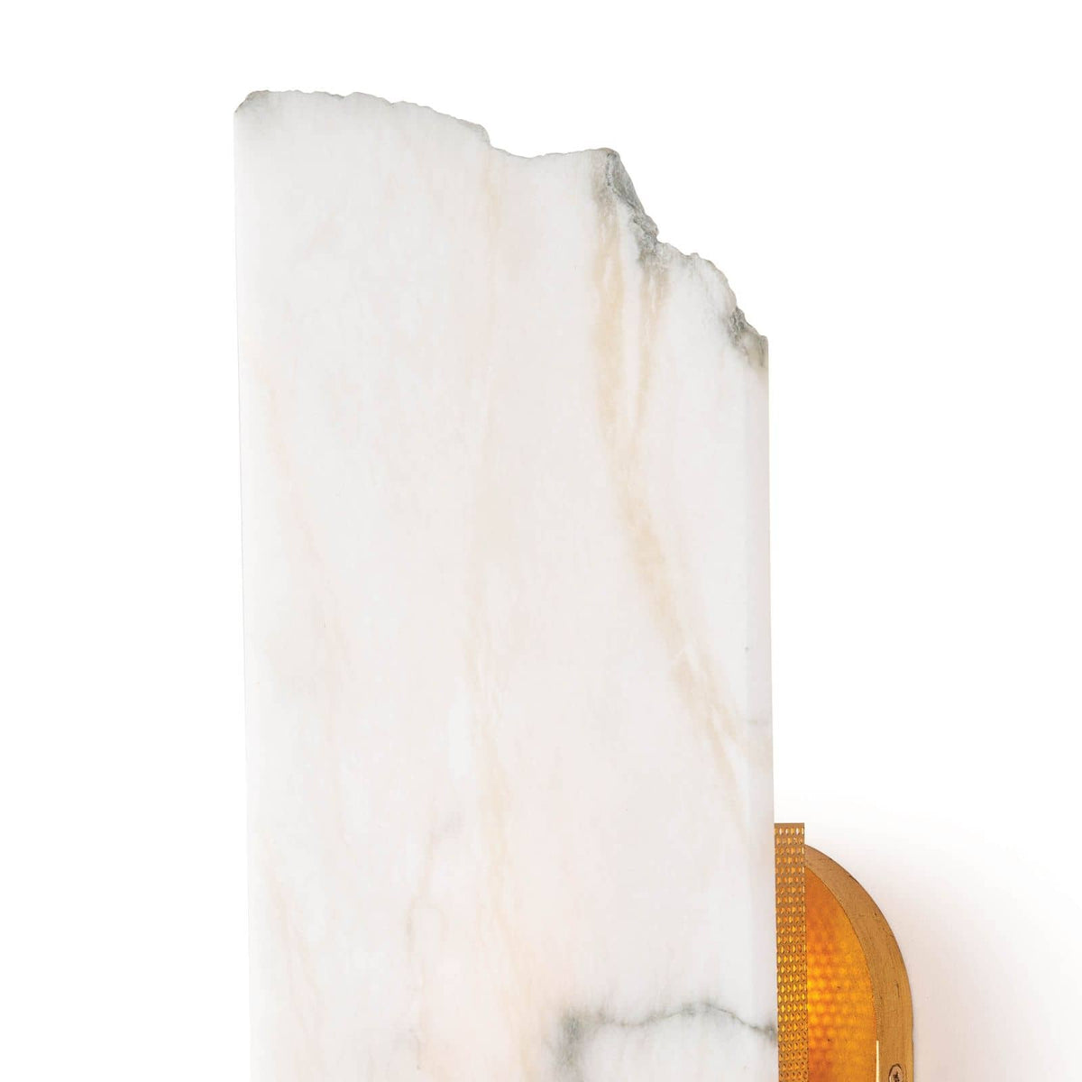 Jonah alabaster sconce with a raw broken edge, white veining, and a warm, diffused glow.