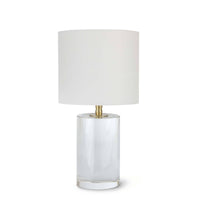 Small Juliet crystal table lamp with a clear cylindrical base, natural brass hardware, and a white linen drum shade.