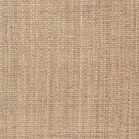 Close-up of a tan, hand-woven jute rug with a visible natural fiber texture.