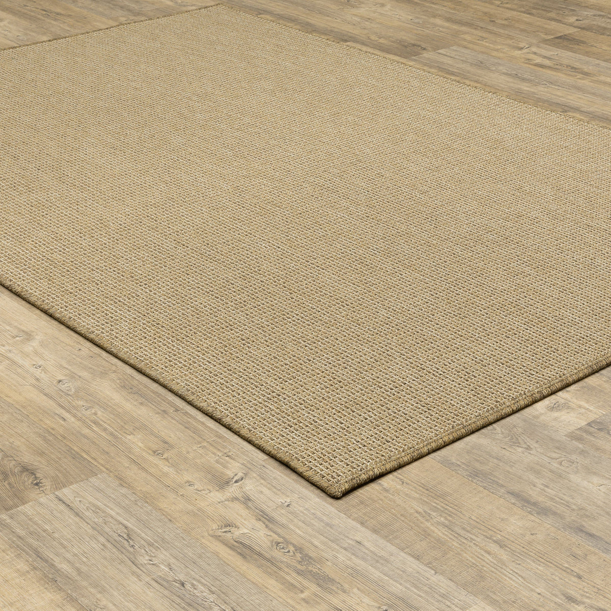 Karavia Sand outdoor rug, a rectangular, power-loomed polypropylene rug with a natural seagrass look on wood flooring.