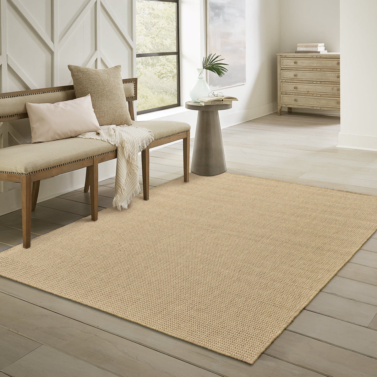 Karavia Sand outdoor rug, a durable, machine-woven polypropylene rug with a natural seagrass look.