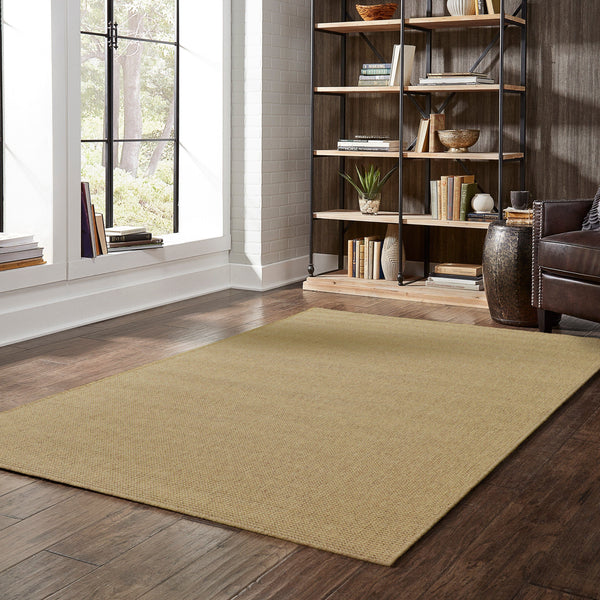 Karavia Tan Outdoor Rug, a durable polypropylene power-loomed rug with a natural seagrass look on a wood floor.