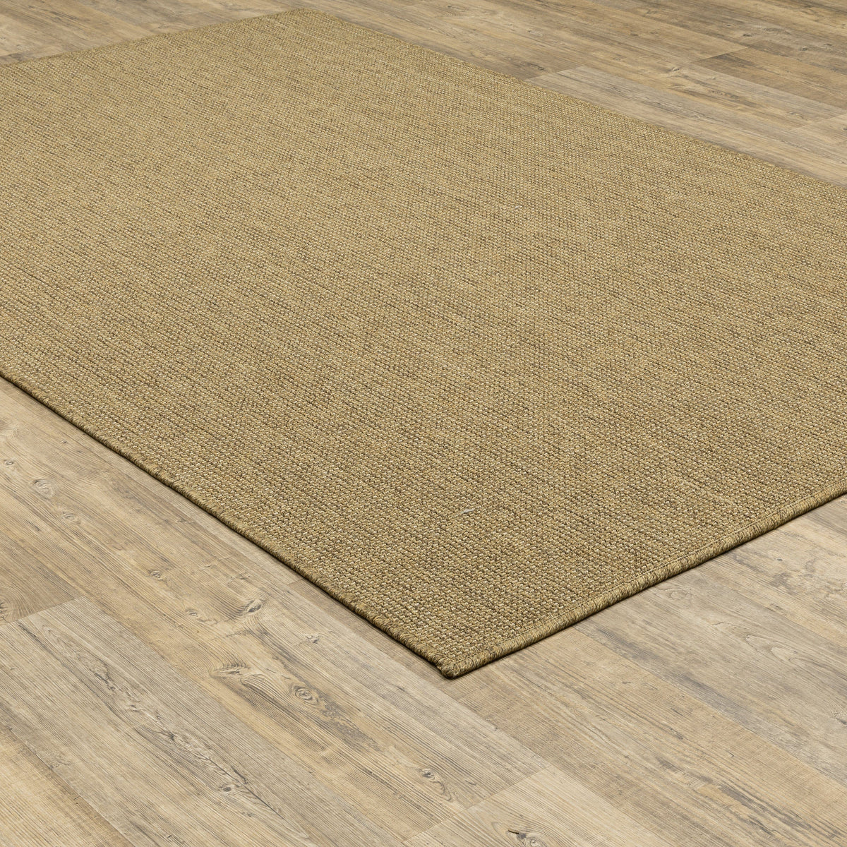 Karavia Tan Outdoor Rug, a durable polypropylene rug with a natural seagrass look on wood flooring.