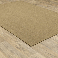 Karavia Tan Outdoor Rug, a durable polypropylene rug with a natural seagrass look on wood flooring.