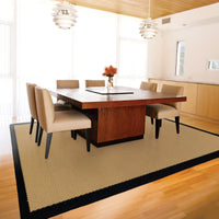 Lanai Beige & Black Outdoor Rug with natural Sisal-inspired weave under a modern dining table.