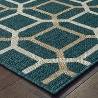 Latitude Blue & Grey outdoor rug with a geometric pattern, made from durable polypropylene, on a wood floor.