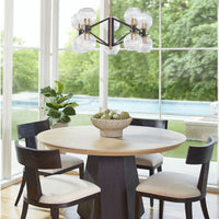 Liam 54" round natural oak dining table with a black oak faceted base and sunburst top.