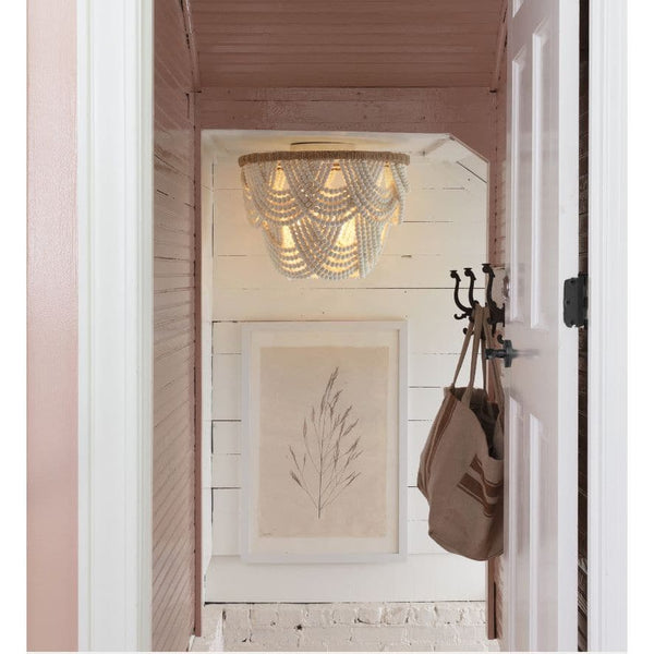 Lorelei white wood bead flush mount light with jute frame in a hallway.