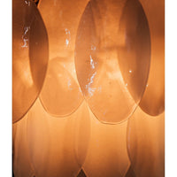 Close-up of a Lotus Petal Chandelier with three tiers of glowing, handcrafted glass petals and an antique brass frame.