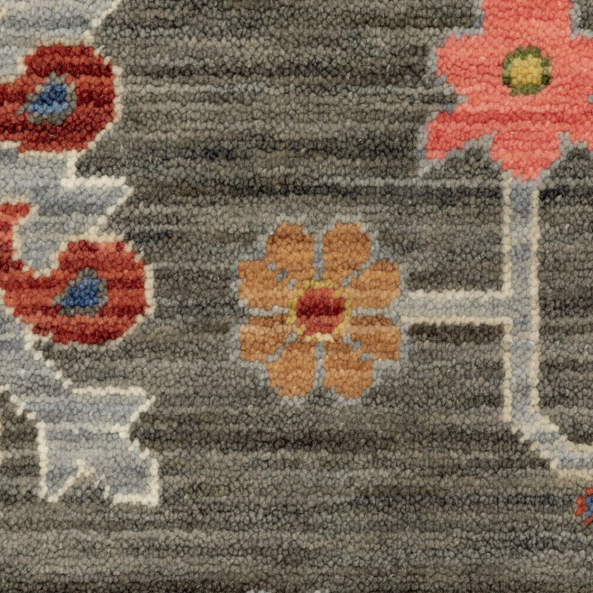 Close-up of Lucca Charcoal & Multi Traditional Rug with space-dyed wool/nylon, featuring floral patterns.