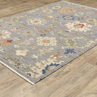 Lucca Grey & Multi Floral Traditional Rug, wool/nylon, power-loomed, on a wood floor.