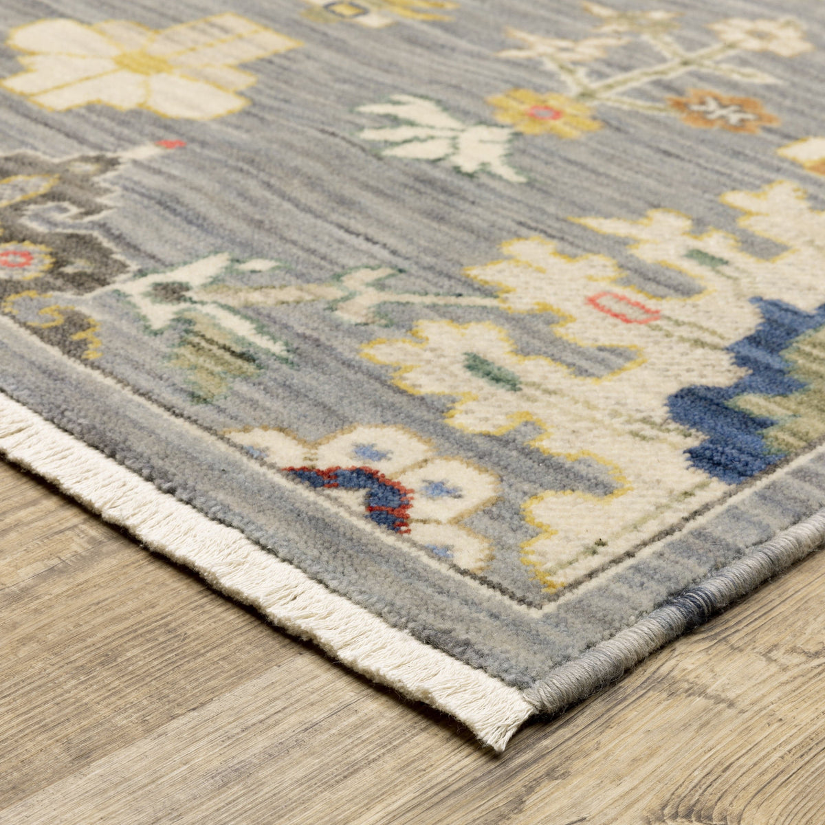 Lucca Grey & Multi Floral Traditional Rug, wool/nylon, with fringe detail on a wood floor.