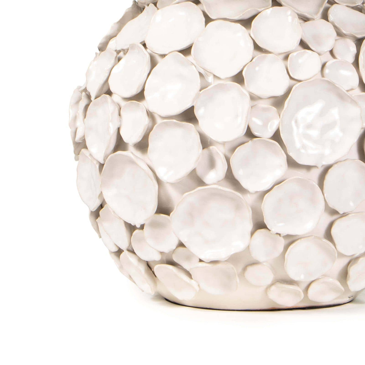 White ceramic table lamp base with multiple hand-crafted, pinched disks in a modern coastal style.