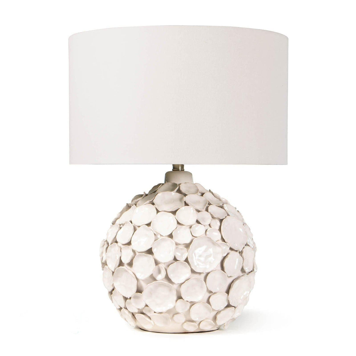 White Lucia ceramic table lamp with a round base of pinched disks and a linen drum shade.
