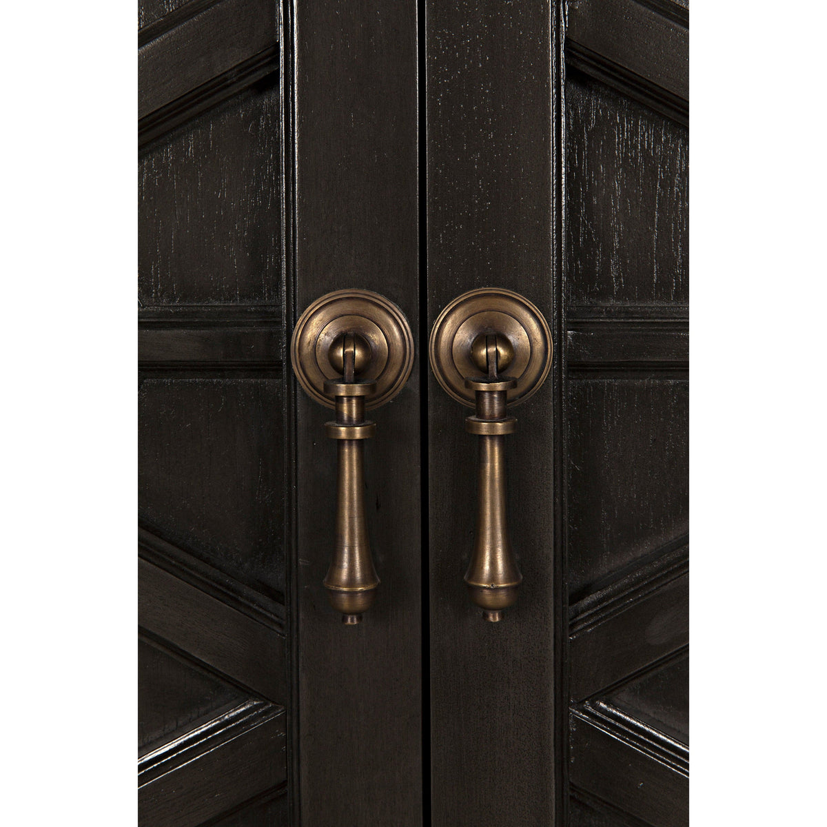 Close-up of a dark burnished mahogany hutch with detailed hand-carving and antique brass drop pull handles.