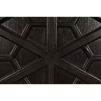 Close-up of a dark burnished mahogany hutch door with intricate geometric hand-carving.