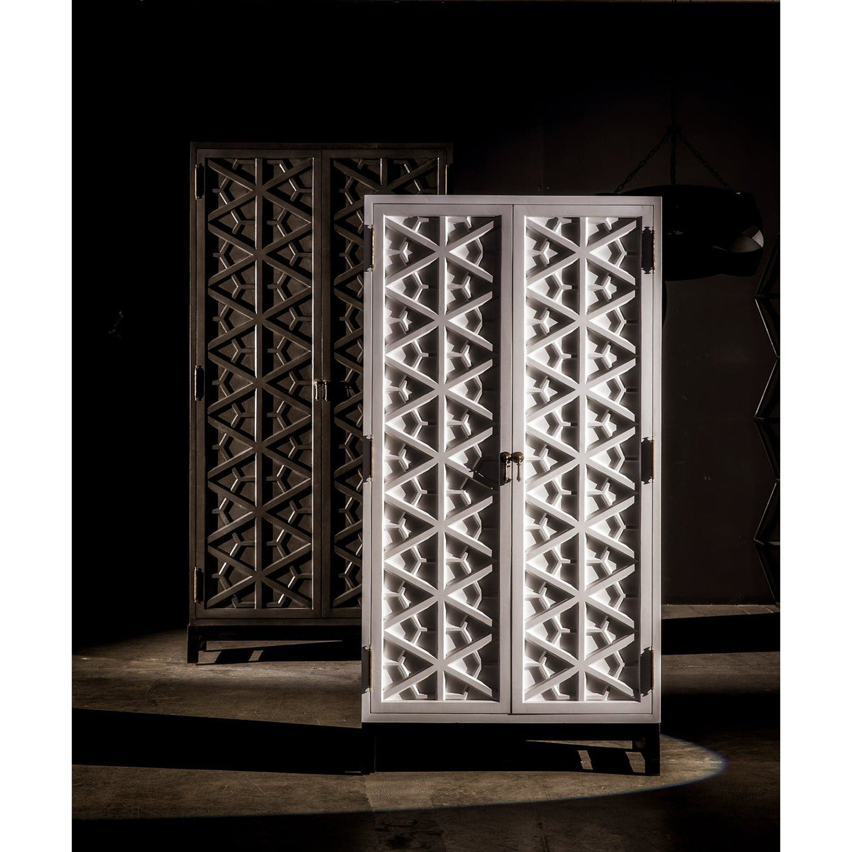 White mahogany hutch with intricate hand-carved geometric doors, next to a darker burnished mahogany version.