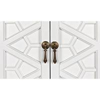 White mahogany hutch doors with intricate geometric hand-carving and antique brass drop pulls.