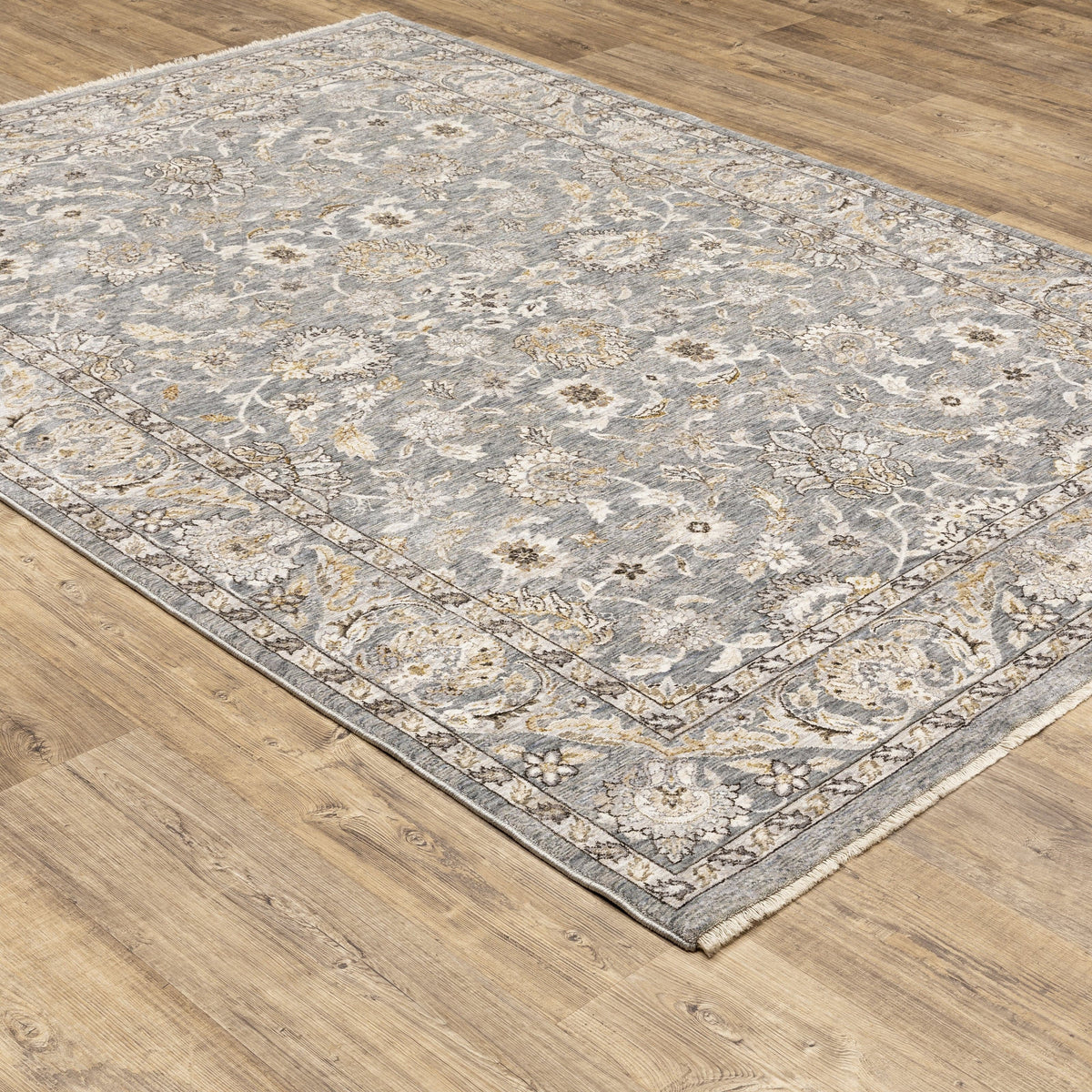 Maharaja Blue & Ivory Traditional Rug with intricate floral patterns on a gray polyester surface.
