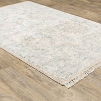 Malabar Beige & Grey casual rug with subtle Persian designs and fringe, on a wood floor.