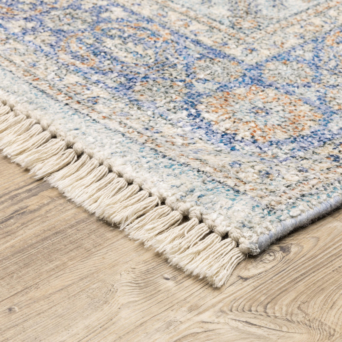 Malabar Blue & Red Traditional Chenille Rug with Persian design and fringe on wood floor.