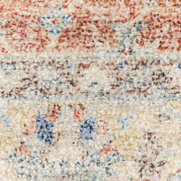 Close-up of a hand-loomed Malabar rug with Persian designs in blues, reds, and warm clay tones.