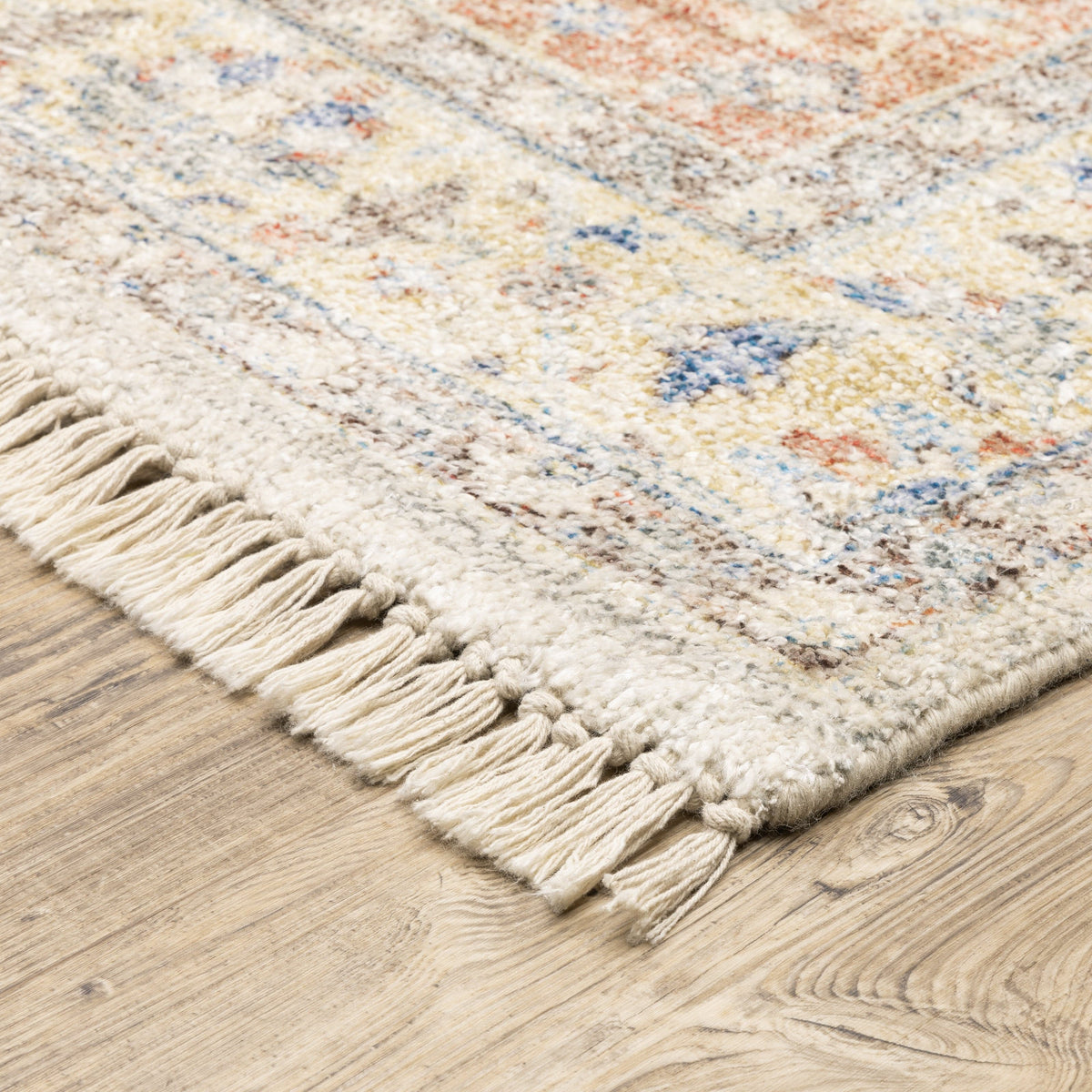 Hand-loomed Malabar traditional rug with Persian designs in blues, reds, and warm clay tones, featuring fringe.