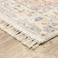 Hand-loomed Malabar traditional rug with Persian designs in blues, reds, and warm clay tones, featuring fringe.