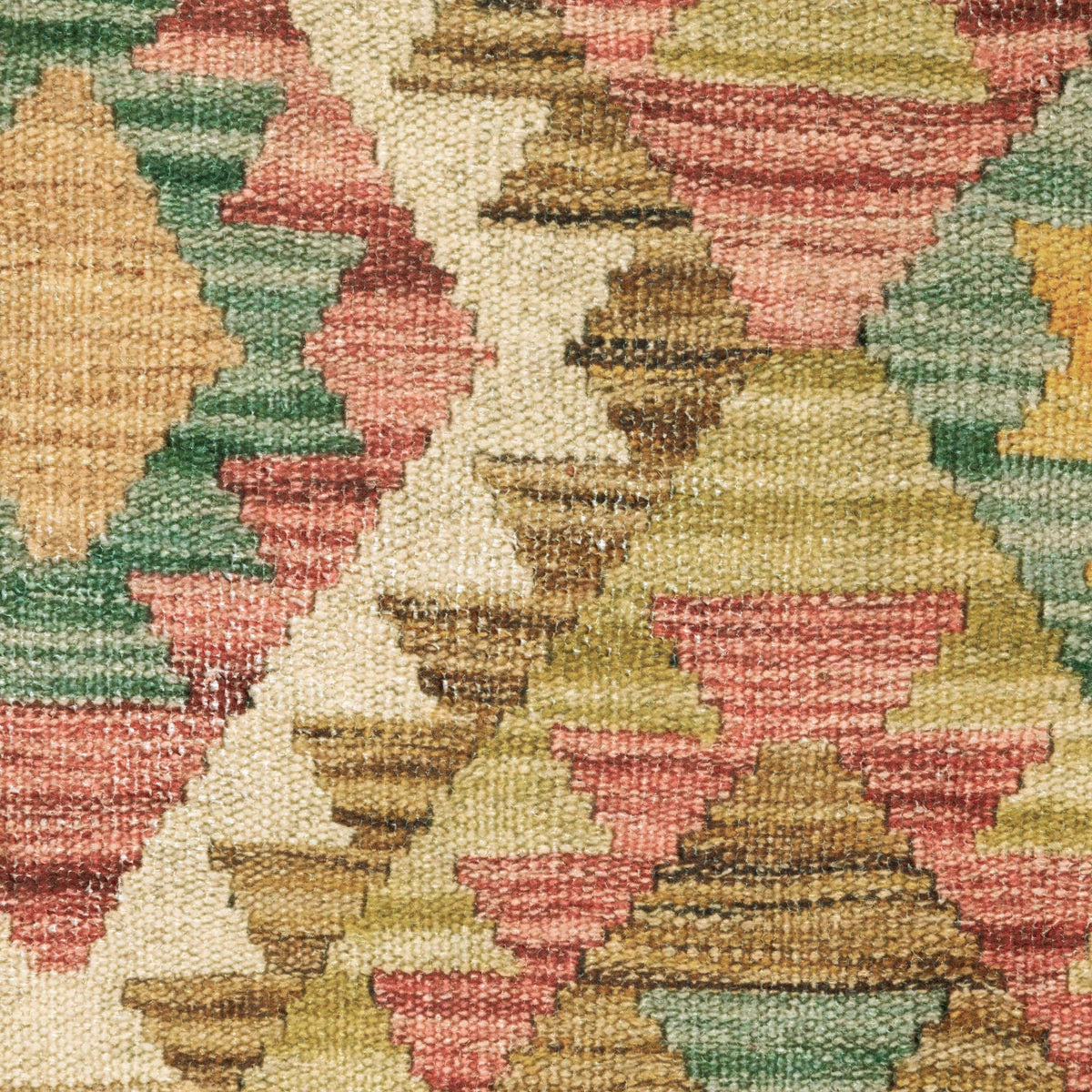 Close-up of Malibu Gold & Multi-Colored Washable Rug with geometric patterns in gold, red, green, and cream.