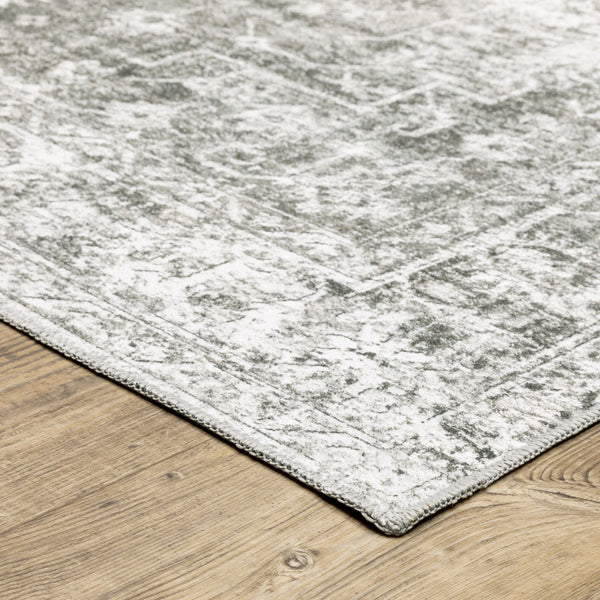 Malibu Grey & Ivory washable polyester rug with distressed abstract design on a wood floor.