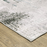 Malibu Grey & Multi washable polyester rug with abstract design on a wooden floor.