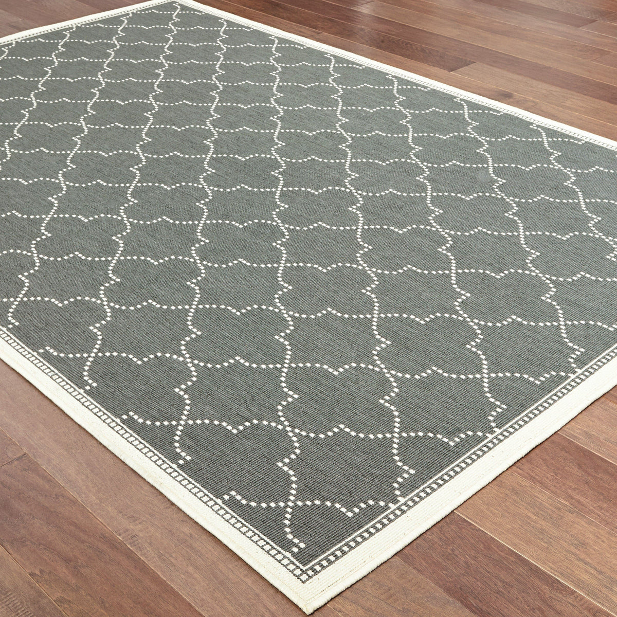Marina Grey & Ivory Outdoor Rug with a geometric white dotted pattern on a dark grey polypropylene weave.