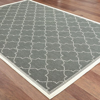 Marina Grey & Ivory Outdoor Rug with a geometric white dotted pattern on a dark grey polypropylene weave.