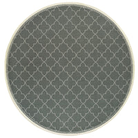 Round Marina Grey & Ivory Outdoor Rug with a quatrefoil pattern and polypropylene looped yarn.