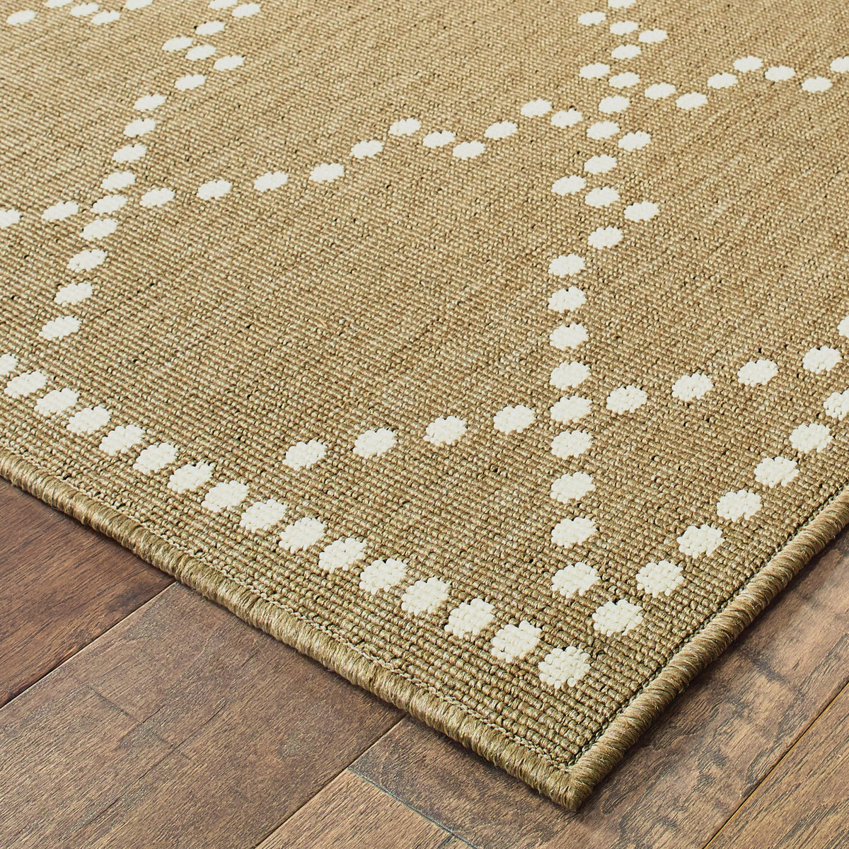 Marina Tan & Ivory Outdoor Rug with a dotted geometric pattern on a woven polypropylene texture.