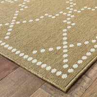 Marina Tan & Ivory Outdoor Rug with a dotted geometric pattern on a woven polypropylene texture.