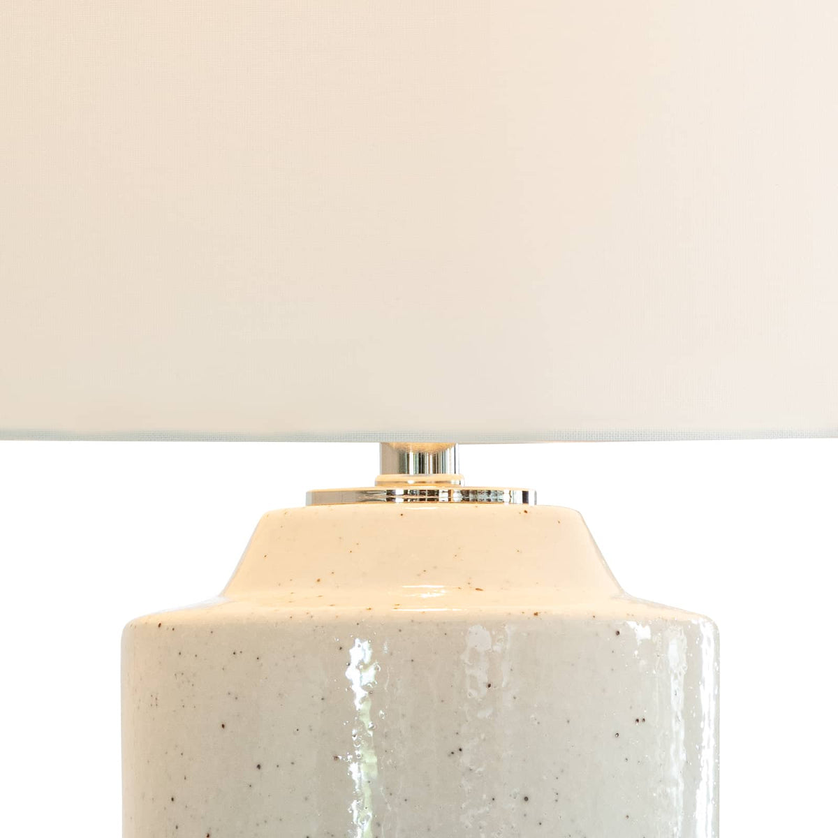 Markus 28.5" ceramic table lamp with a freckled neutral body, polished nickel accents, and a crisp natural linen drum shade.