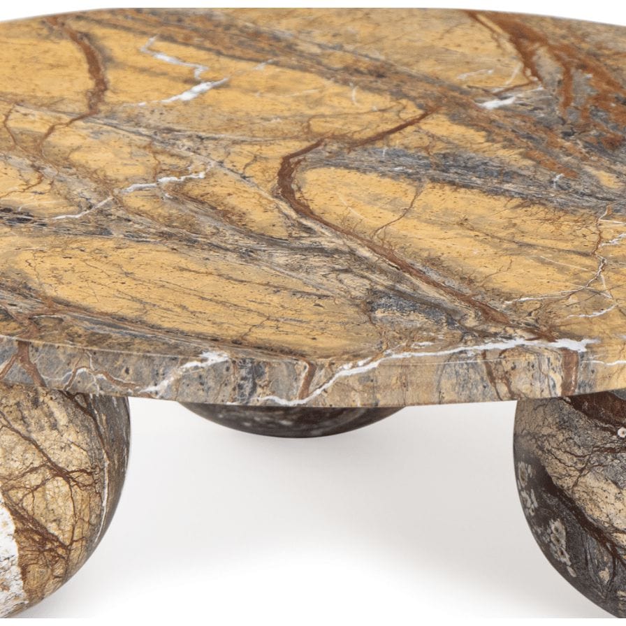 Round Marlow brown marble plate with natural veining, supported by three spherical marble feet.
